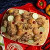 a platter of food on a red cloth